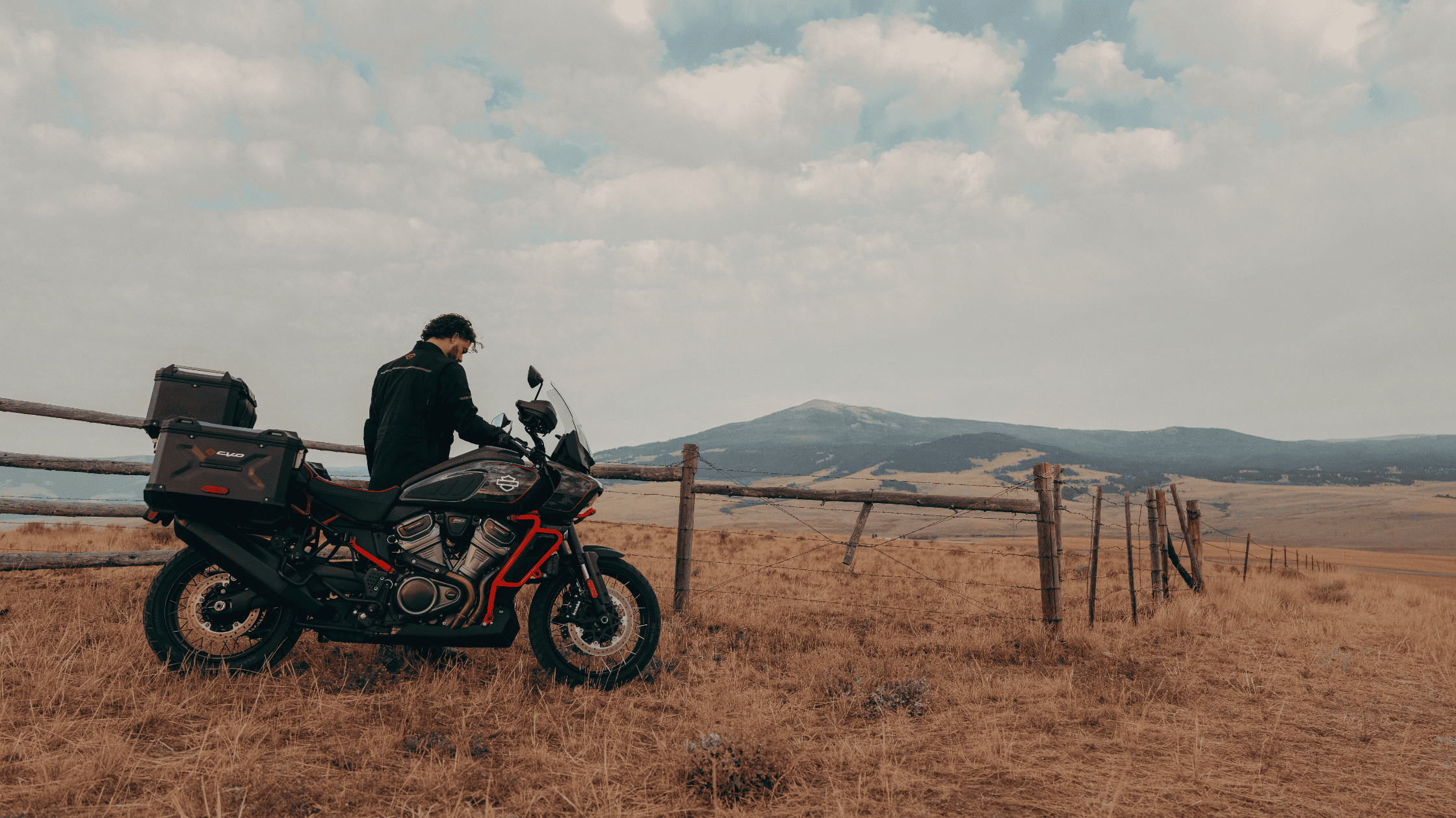 Rider with 2025 H-D® CVO™ Pan America® parked on open countryside with mountains in view
