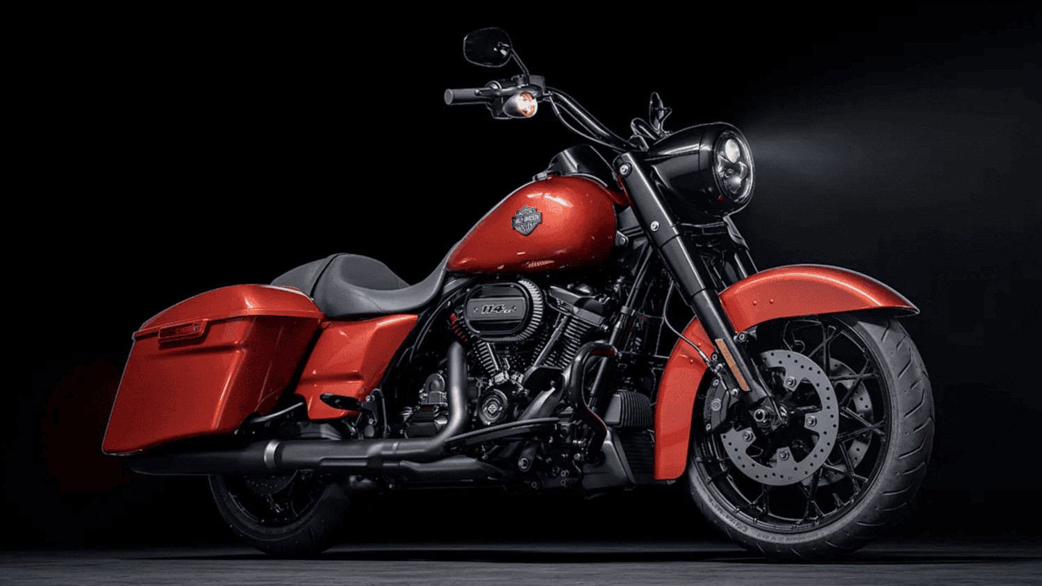 A bold red 2025 Harley-Davidson&reg; Road King&reg; Special showcased under sleek black studio lighting